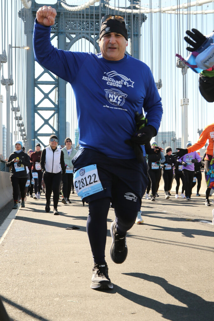 Rob Capolongo running the NYC Half Marathon across the Manhattan Bridge